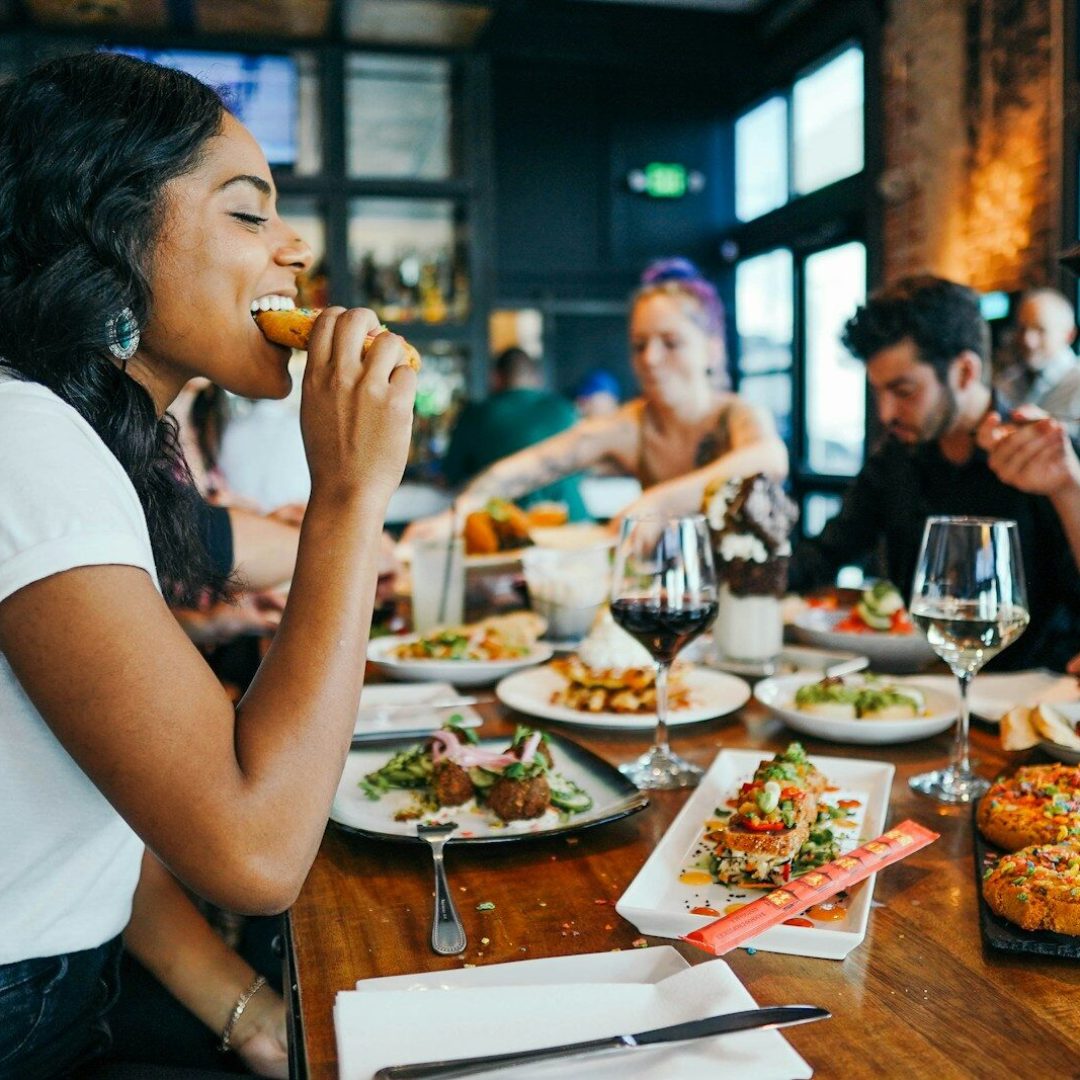 woman in white shirt eating
